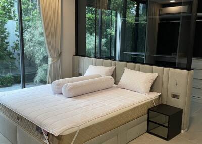 Modern bedroom with large windows and a bed