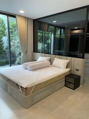 Modern bedroom with large windows and a bed