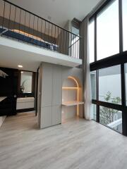 Modern living area with loft, large windows, and built-in desk