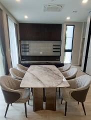 Modern dining room with marble table and upholstered chairs