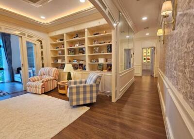 Spacious living area with bookshelves and armchairs