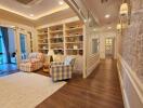 Spacious living area with bookshelves and armchairs