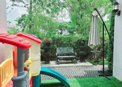 Outdoor play area with slide and sitting bench