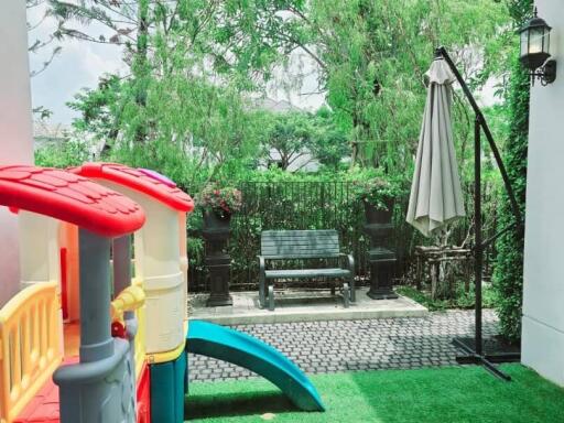 Outdoor play area with slide and sitting bench