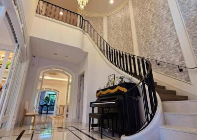 Elegant foyer with piano and chandelier