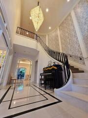 Elegant foyer with piano and chandelier