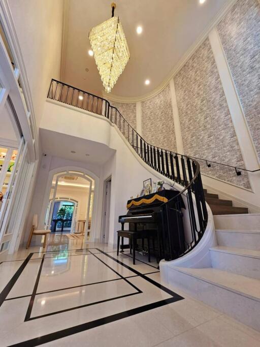 Elegant foyer with piano and chandelier