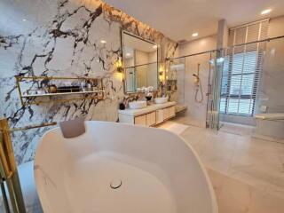 Luxury master bathroom with marble wall and freestanding bathtub