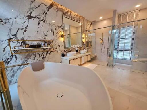 Luxury master bathroom with marble wall and freestanding bathtub