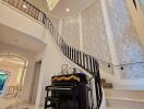 Elegant staircase with chandelier and piano