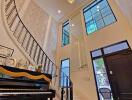 Elegant main living space with a grand staircase and chandelier