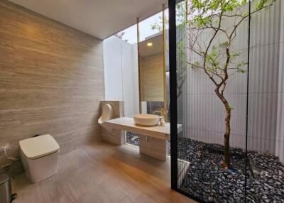 Modern bathroom with large window and natural elements