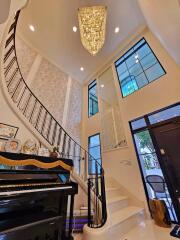 Stunning modern staircase with chandelier in a luxurious foyer