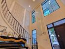 Stunning modern staircase with chandelier in a luxurious foyer