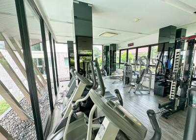 Gym with various exercise equipment and large windows