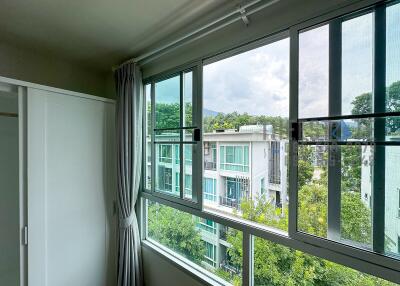 Bedroom with a large window offering a scenic view