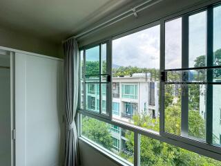 Bedroom with a large window offering a scenic view