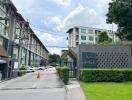 Entrance of a residential complex with buildings in the background