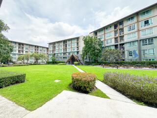 exterior view of multi-story apartment buildings with green lawn