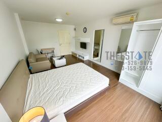 Spacious bedroom with modern furnishings and natural light