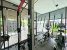 Residential gym with fitness equipment and large windows