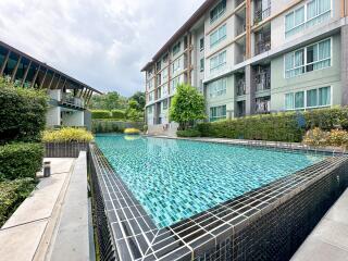 Outdoor swimming pool with adjacent modern apartment buildings