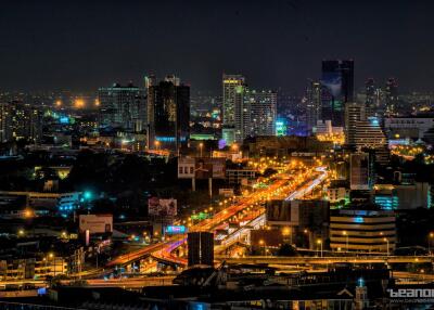 Night view of a bustling city with skyscrapers and highways