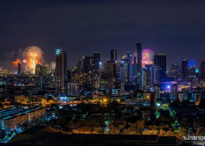 Night view of a city skyline with fireworks