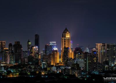 Nighttime cityscape with illuminated skyscrapers