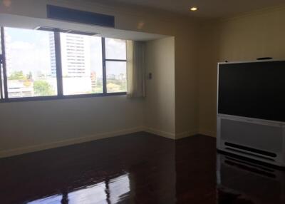 Living room with large windows and a television