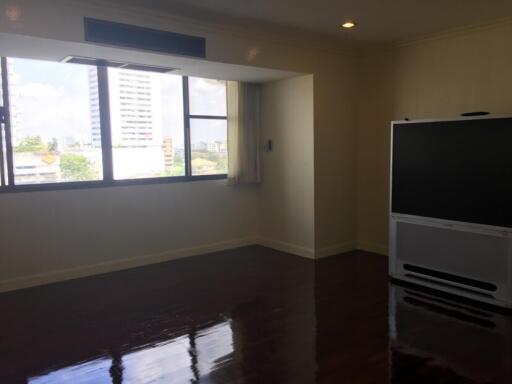 Living room with large windows and a television