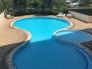 Outdoor swimming pool area with city skyline