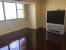 Living room with large window and television