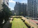 View of a residential area with high-rise buildings and a well-maintained garden