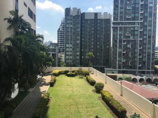 View of a residential area with high-rise buildings and a well-maintained garden