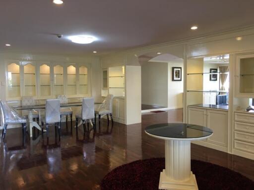 Elegant dining area with glass cabinets and a circular table