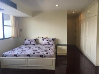 Spacious bedroom with large windows and fitted wardrobes