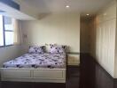 Spacious bedroom with large windows and fitted wardrobes