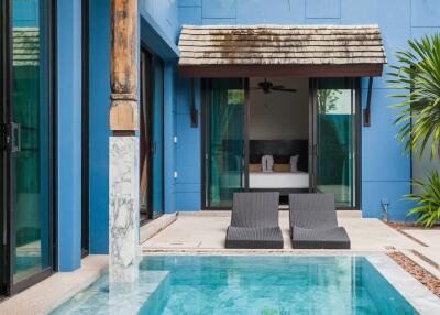 Pool area with lounge chairs and view of a building