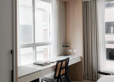 Modern bedroom with a study nook and large windows