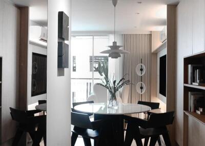 Modern dining area with a round table and stylish chairs