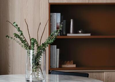 Modern dining area with round marble table and plant centerpiece