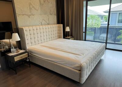 Modern bedroom with large bed and natural light