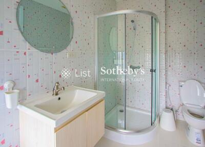 Modern bathroom with sink, shower cabin, and toilet