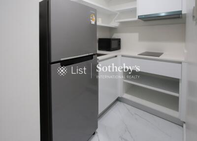 Modern kitchen with silver refrigerator and white cabinets