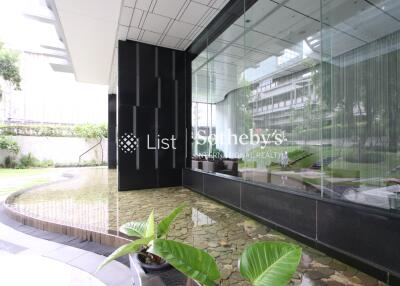 Modern building exterior with landscaped garden and water feature