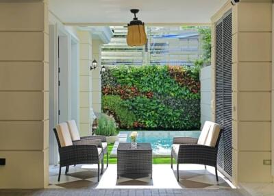 Patio with seating area and view of swimming pool