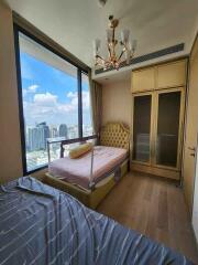 Bedroom with large windows and city view