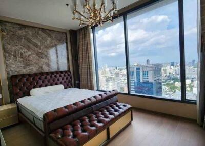 Modern bedroom with large windows and city view