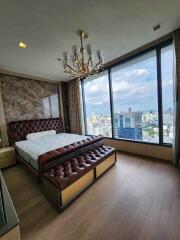 Modern bedroom with large windows and city view